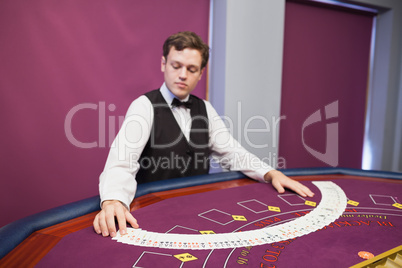 Dealer spreading deck of cards