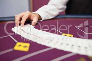Dealer spreading the deck at poker