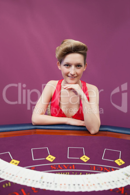 Woman at poker table with spread deck