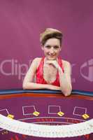Woman at poker table with spread deck
