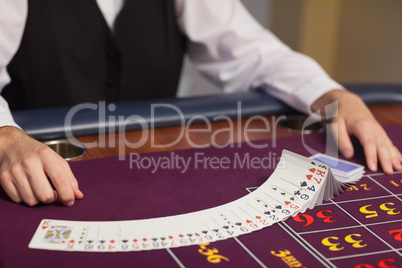 Dealer dealing out cards at roulette table