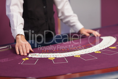 Man dealing out cards in a casino