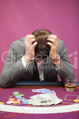 Depressed man playing poker