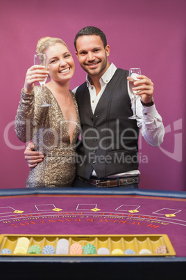 Two people toasting in a casino