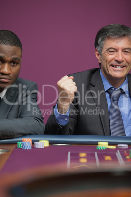 Smiling man celebrating roulette win