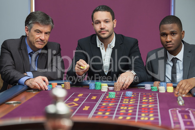 Three men playing roulette