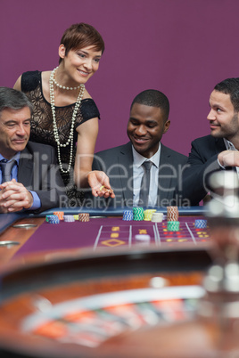 Woman placing bet at roulette table