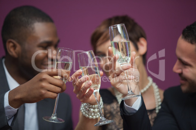 Three people toasting and celebrating in a casino