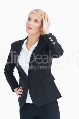 Woman looking up while touching her head