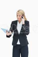 Blonde looking at her tablet while calling