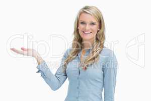 Cheerful woman presenting something