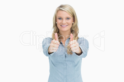 Blonde woman cheerfully doing thumbs up