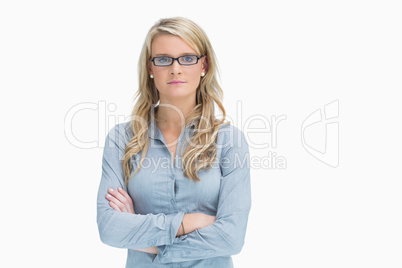 Woman wearing glasses while crossing arms