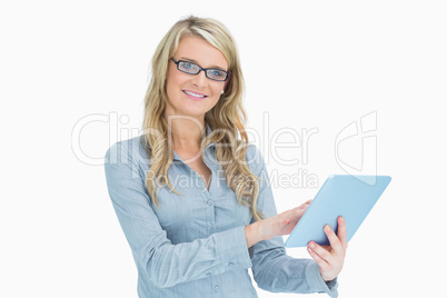 Smiling woman touching on tablet