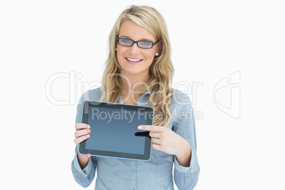 Woman wearing glasses and pointing on her tablet
