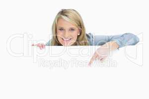 Cheerful woman pointing down