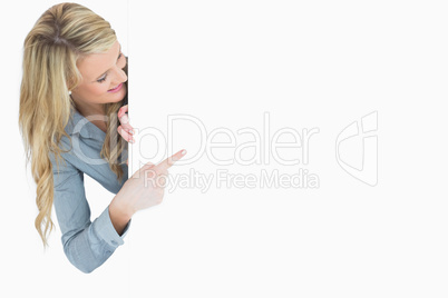 Happy woman pointing on poster