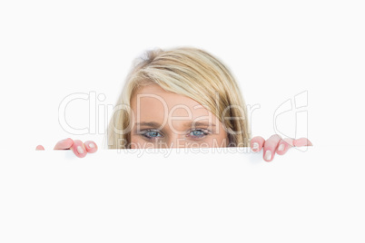Woman hiding behind a notice