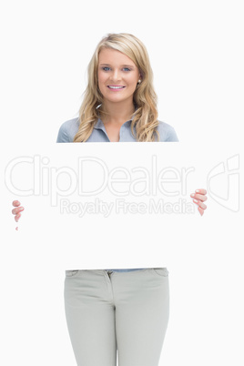 Blonde woman holding a poster