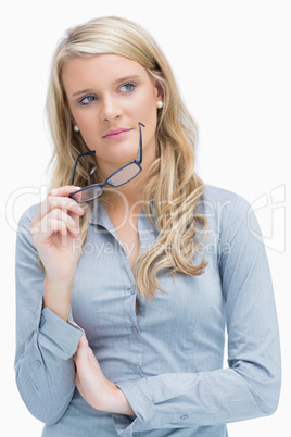 Woman taking glasses off