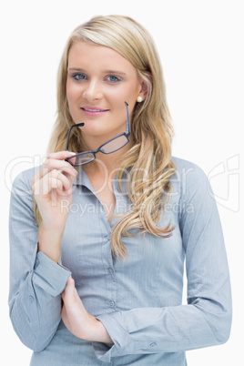 Woman removing glasses