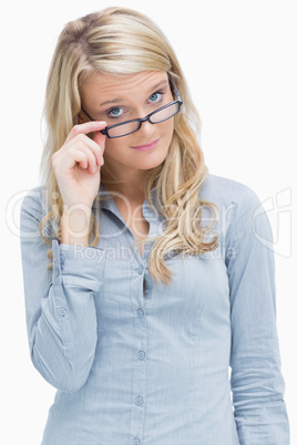 Woman looking above her glasses