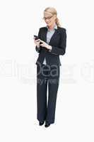 Businesswoman standing and using mobile phone