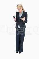 Business woman looking angrily at mobile phone