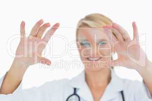 Doctor holding up clear pane and smiling