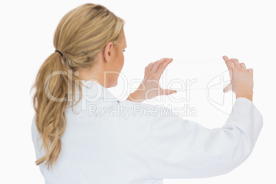 Doctor holding glass slide from behind