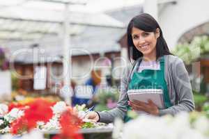 Employee taking notes in garden centre