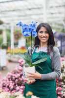Woman holding a flower in the garden centre