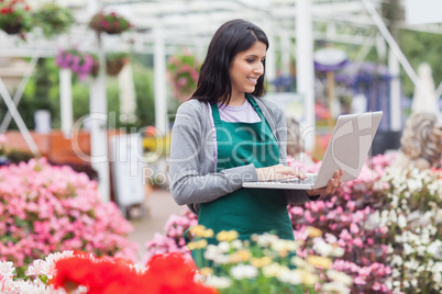 Woman doing stocktaking with laptop