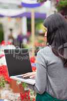 Florist using a laptop