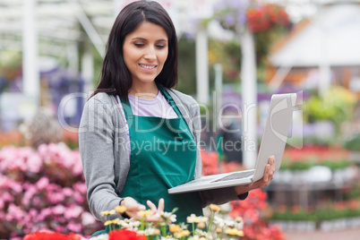 Woman checking stocks in garden center