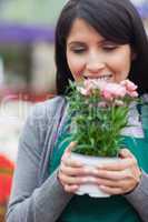 Florist holding flower while smelling it
