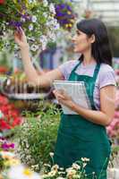 Brunette viewing flowers and taking notes