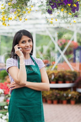 Florist doing a phone call while smiling