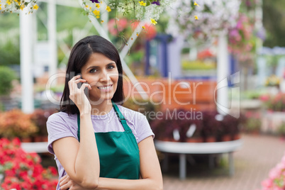 Woman working in garden center making a call