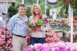 Joyful couple holding flowers
