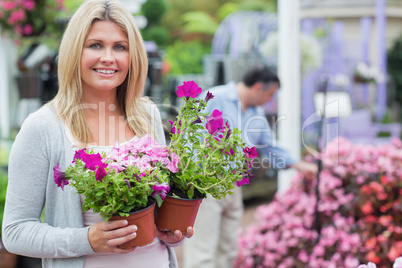 Customer holding flowers while smiling