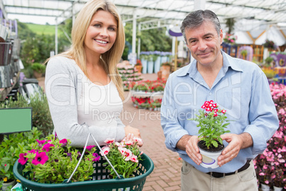 Couple choosing flowers in garden center