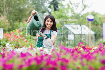 Happy employee watering plants