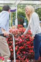 Couple talking while choosing flowers