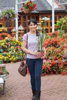 Woman carrying daisy plant