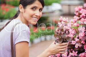 Woman smiling while holding a flower