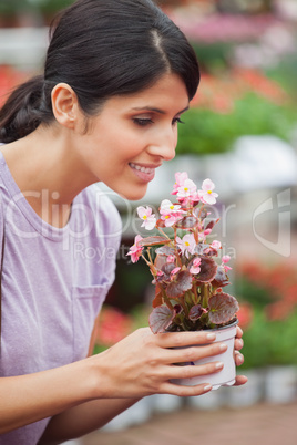 Woman holding a flower and smelling