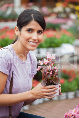 Woman holding a flower while smiling