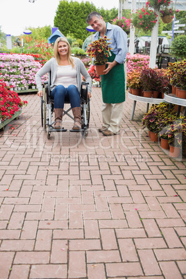 Garden center employee and woman in wheelchair