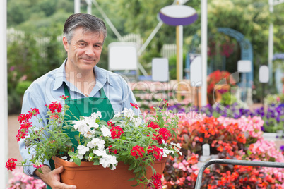 Man holding pot with flowers